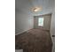 Carpeted bedroom with a bright window and natural light at 403 Buckboard Ln, Locust Grove, GA 30248