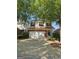 Charming two-story home with brick accents, attached garage, and mature trees at 403 Buckboard Ln, Locust Grove, GA 30248