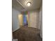 Hallway with carpet flooring and multiple doorways, providing easy access to rooms at 403 Buckboard Ln, Locust Grove, GA 30248