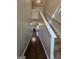 Bright hallway featuring hardwood floors, stairs to the second floor, and a view of the living room at 403 Buckboard Ln, Locust Grove, GA 30248