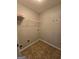 Dedicated laundry room area showcasing tiled floors and essential utility connections at 403 Buckboard Ln, Locust Grove, GA 30248