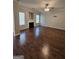 Spacious living room with hardwood floors, fireplace, and large windows for natural light at 403 Buckboard Ln, Locust Grove, GA 30248