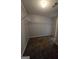 Carpeted walk-in closet with built-in shelving to maximize storage capacity at 403 Buckboard Ln, Locust Grove, GA 30248