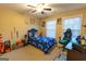 Nicely decorated bedroom with a ceiling fan, comfortable bed and natural light from large windows at 6089 Indian Wood Se Cir, Mableton, GA 30126