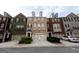 Charming multi-colored townhomes, featuring a beige townhome in the center, each with a front-entry garage and manicured landscaping at 6089 Indian Wood Se Cir, Mableton, GA 30126