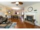 Open concept living space with a fireplace, hardwood floors, and seamless flow to dining and kitchen areas at 6089 Indian Wood Se Cir, Mableton, GA 30126