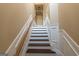Elegant staircase with wood and white trim, offering a smooth transition between floors in a neutrally decorated home at 6089 Indian Wood Se Cir, Mableton, GA 30126