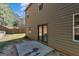 View of the backyard with a concrete patio and a sliding door leading into the home at 820 Lake Chase, Fairburn, GA 30213