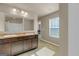 Well-lit bathroom with double sinks, a large mirror, and a combination tub-shower at 820 Lake Chase, Fairburn, GA 30213