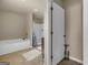 Bright bathroom featuring a bathtub and tiled floors at 820 Lake Chase, Fairburn, GA 30213