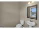 A half-bathroom featuring a toilet and a pedestal sink at 820 Lake Chase, Fairburn, GA 30213