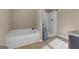 Bathroom featuring a soaking tub and separate shower, perfect for relaxation at 820 Lake Chase, Fairburn, GA 30213