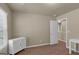 A bedroom features neutral walls, carpet, and simple furniture at 820 Lake Chase, Fairburn, GA 30213
