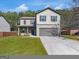 Charming two-story home featuring a gray exterior, well-maintained lawn, and a welcoming front porch at 820 Lake Chase, Fairburn, GA 30213