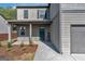 Inviting front porch with welcoming signage and neatly landscaped yard for curb appeal at 820 Lake Chase, Fairburn, GA 30213