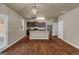 Open kitchen with stainless steel appliances, granite countertops, and a large center island for dining at 820 Lake Chase, Fairburn, GA 30213