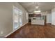 Open kitchen concept with stainless appliances, dark wood cabinets, flowing to the living space at 820 Lake Chase, Fairburn, GA 30213