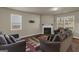 Cozy living room features a fireplace, hardwood floors, and natural light from bright windows at 820 Lake Chase, Fairburn, GA 30213
