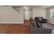 Spacious living room with hardwood floors, plush furniture, and ample natural light from the windows at 820 Lake Chase, Fairburn, GA 30213