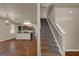 View of the modern kitchen and adjacent carpeted staircase with white railing at 820 Lake Chase, Fairburn, GA 30213