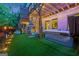 Cozy backyard with a hot tub, artificial turf, and a hanging chair for outdoor relaxation at 3028 Pruitt Ln, Smyrna, GA 30080