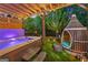 Inviting backyard with a hot tub, a lounge seat, and a pergola with string lights at 3028 Pruitt Ln, Smyrna, GA 30080