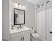Modern bathroom features a vanity with black fixtures and a shower/tub combination with a white shower curtain at 3028 Pruitt Ln, Smyrna, GA 30080