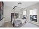 Stylish bedroom featuring a modern four-poster bed, neutral colors, and large windows for natural light at 3028 Pruitt Ln, Smyrna, GA 30080
