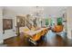 Dining area with a modern chandelier, wooden floors, and a view into the living room at 3028 Pruitt Ln, Smyrna, GA 30080