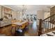 Open concept dining area with modern chandelier, staircase, and access to the kitchen and living spaces at 3028 Pruitt Ln, Smyrna, GA 30080