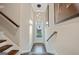 Bright entryway with hardwood floors, a glass-paneled front door, and a modern light fixture at 3028 Pruitt Ln, Smyrna, GA 30080