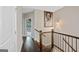 Hallway with wood floor and railing leading to a bedroom at 3028 Pruitt Ln, Smyrna, GA 30080