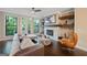 Cozy living room featuring a fireplace, hardwood floors, and access to an outdoor deck at 3028 Pruitt Ln, Smyrna, GA 30080