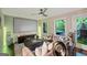 Inviting living room featuring a ceiling fan, large screen, and natural light streaming in from the windows at 3028 Pruitt Ln, Smyrna, GA 30080