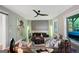 Comfortable living room features stylish furnishings, ceiling fan, and ample natural light through large windows at 3028 Pruitt Ln, Smyrna, GA 30080