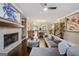 Spacious living room with a fireplace, modern decor, and an open view to the dining area and kitchen at 3028 Pruitt Ln, Smyrna, GA 30080