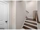 Elegant stairway with dark wood steps, white risers, and a dark wood handrail at 3028 Pruitt Ln, Smyrna, GA 30080