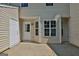 Back patio of home has door to the inside, and a window to let light into the home at 1372 Hollenbeck Ln, Riverdale, GA 30296