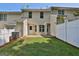 The backyard features green grass and a white fence that borders the property at 1372 Hollenbeck Ln, Riverdale, GA 30296