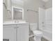 Well-lit bathroom features a vanity, toilet, and bathtub with shower, all in a clean, neutral palette at 1372 Hollenbeck Ln, Riverdale, GA 30296