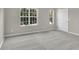 Spacious bedroom with carpet flooring, large windows, and a neutral color scheme for a cozy feel at 1372 Hollenbeck Ln, Riverdale, GA 30296