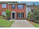 Charming brick townhome featuring black shutters, large windows, and a well-maintained front yard at 1372 Hollenbeck Ln, Riverdale, GA 30296