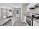 Modern kitchen featuring granite countertops, stainless steel appliances, and white cabinets at 1372 Hollenbeck Ln, Riverdale, GA 30296
