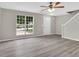 The living room features hardwood floors, a ceiling fan, and a window with a view at 1372 Hollenbeck Ln, Riverdale, GA 30296