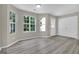 Inviting living room boasts laminate floors, natural light from windows, and easy access to a closet at 1372 Hollenbeck Ln, Riverdale, GA 30296