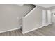 Bright staircase leads to the upper level, with laminate floors and natural light in the background at 1372 Hollenbeck Ln, Riverdale, GA 30296