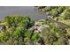 Aerial view of a unique home with a red roof and waterfront access, nestled among mature trees at 8655 Shoreline Dr, Jonesboro, GA 30236
