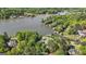 Gorgeous aerial shot showcasing a lake house with a red roof surrounded by lush trees and lake views at 8655 Shoreline Dr, Jonesboro, GA 30236
