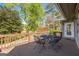Outdoor back deck with seating and a scenic view of the yard, perfect for entertaining or relaxing at 8655 Shoreline Dr, Jonesboro, GA 30236