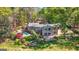 Lush backyard with pool, patio, mature trees, and an outdoor entertainment area, a serene spot for Gathering and friends at 8655 Shoreline Dr, Jonesboro, GA 30236